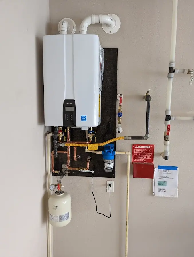 Professional plumber installing copper piping in a Bisbee home